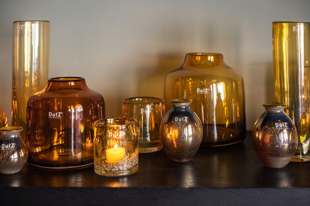 Several gold coloured glass vases on a table